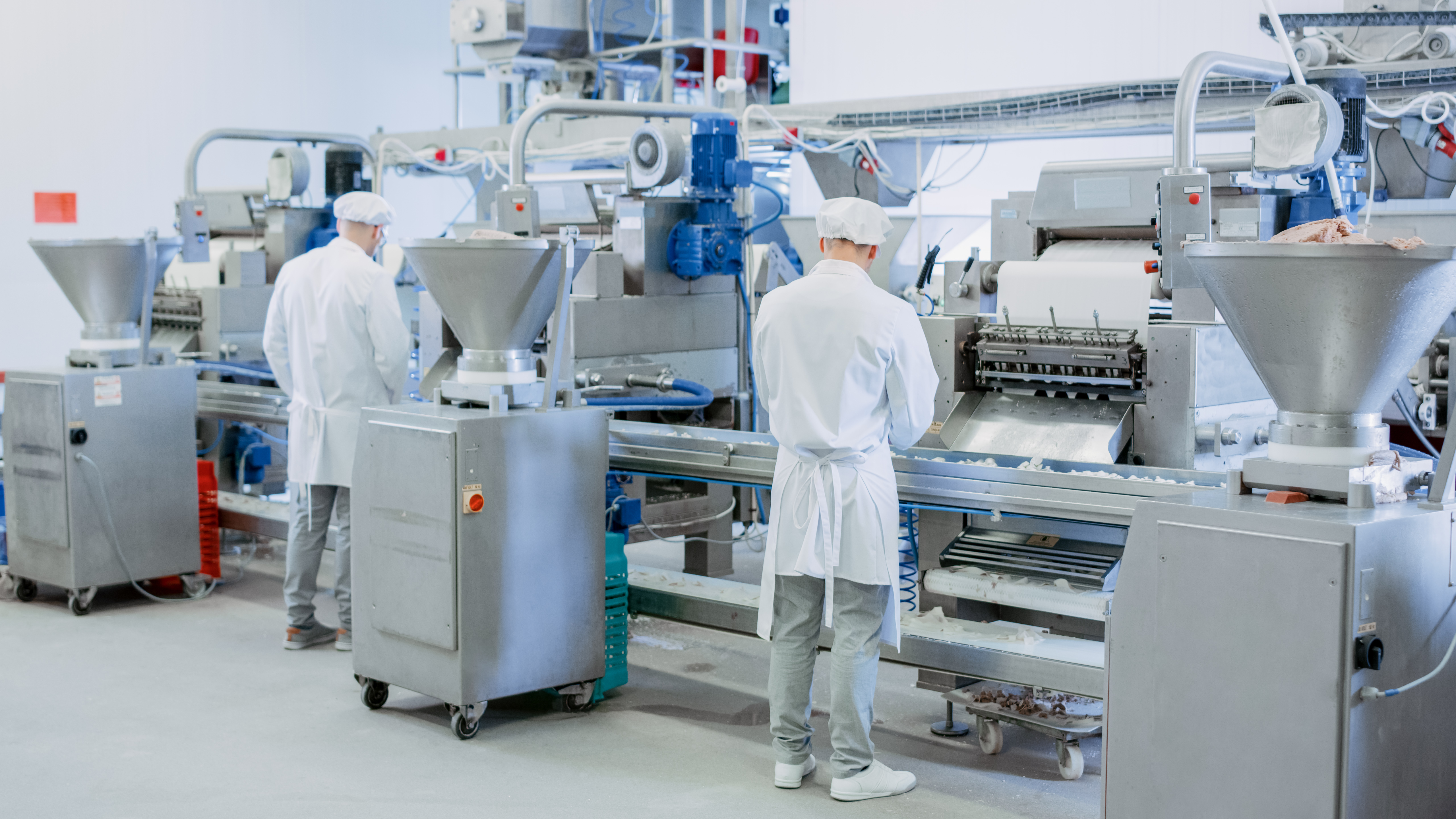 Two,Young,Male,Food,Conveyor,Belt,Employees,Work,At,A